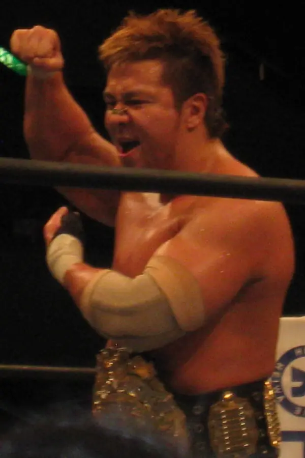 Kojima shouts, the IWGP Heavyweight belt around his waist
