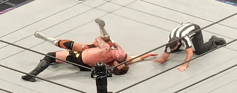 Kojima and CM Punk in the ring, seen from the stands